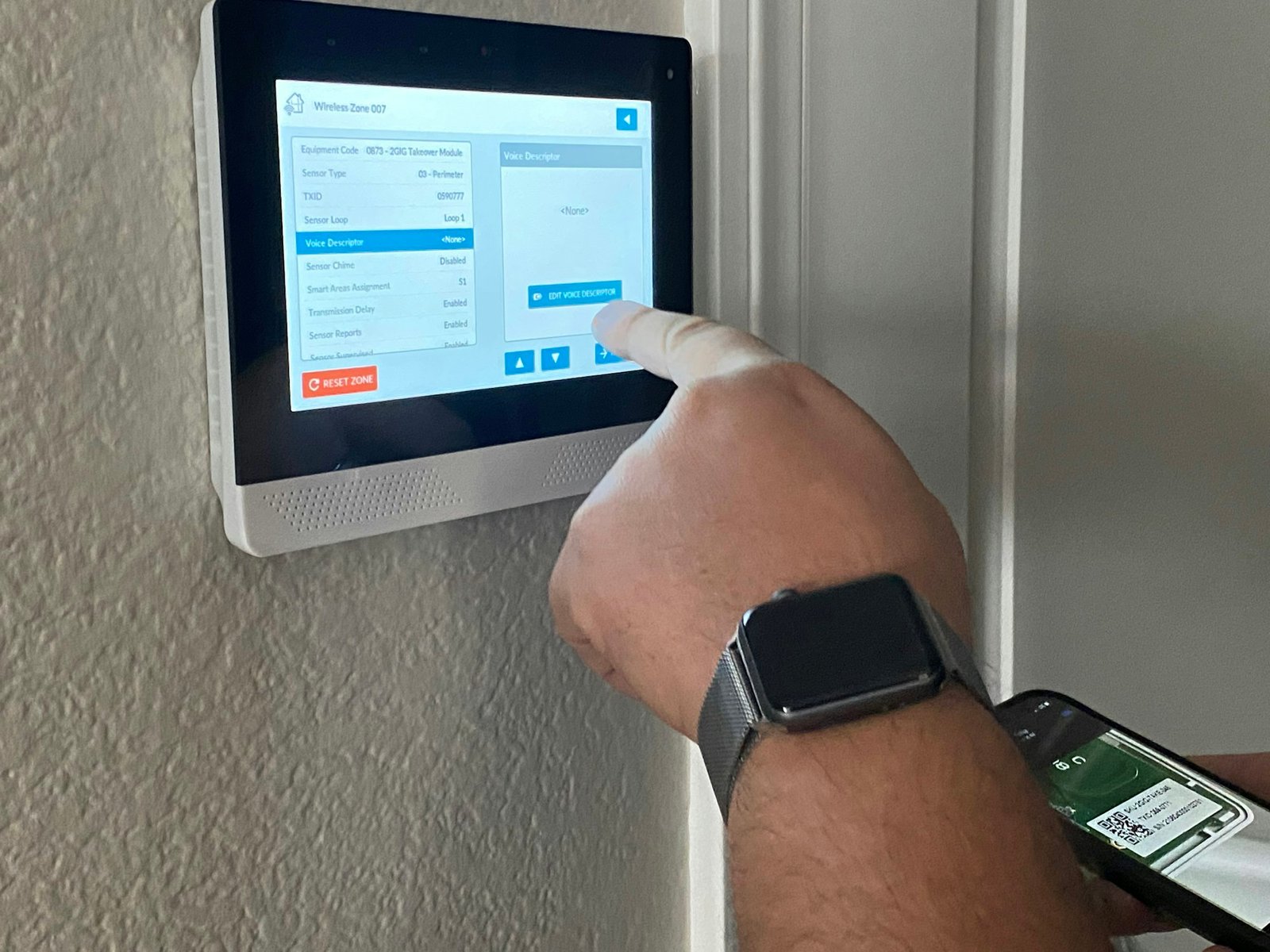 An elite technician programs a new Edge alarm panel in a home